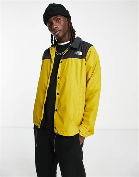 The North Face water repellent coach jacket in yellow and black .